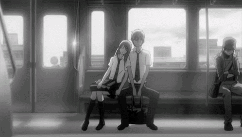 a boy and a girl are sitting on a bus .