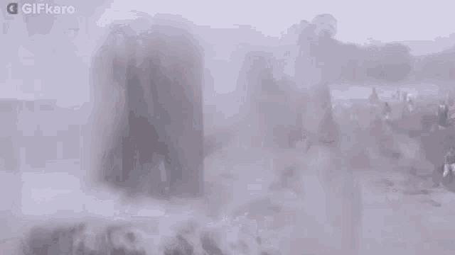 a man is standing in a pool of water surrounded by steam .