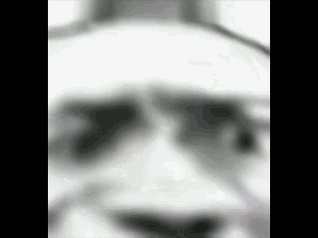 a close up of a person 's face wearing sunglasses .