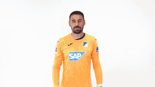 a soccer player wearing an orange shirt with the word sap on it