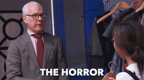 a man in a suit and tie is talking to a girl who is holding a jacket and the words the horror are on the screen