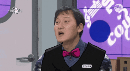 a man with a pink bow tie has a name tag that says ' a.m. ' on it