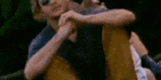 a man and a woman are hugging each other in a blurry picture .