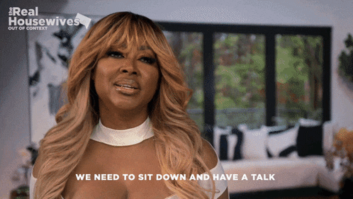 a woman says " we need to sit down and have a talk " in a living room