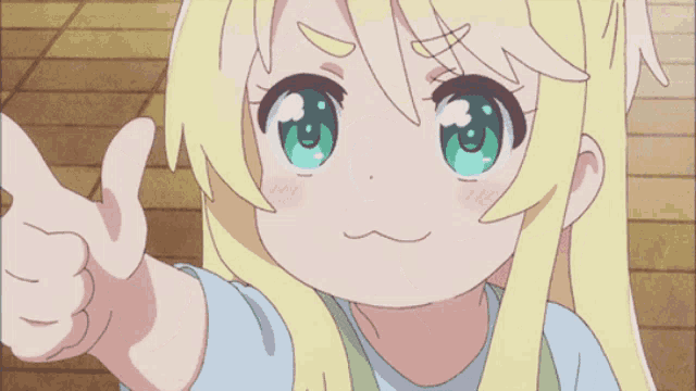 a little girl with blonde hair and green eyes is pointing at something