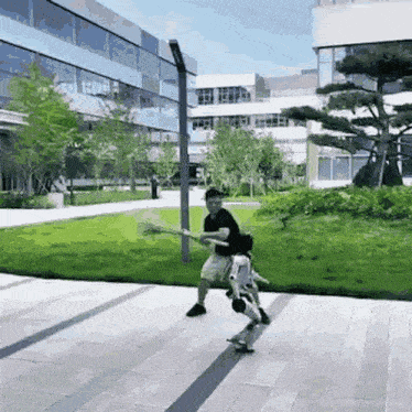 a man is riding a skateboard on a sidewalk in front of a building