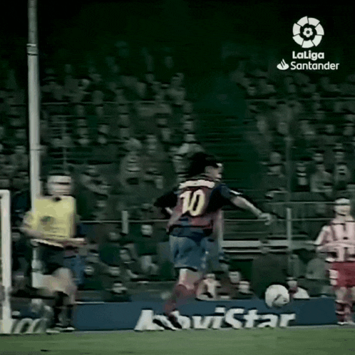 a soccer player wearing a number 10 jersey is kicking a ball