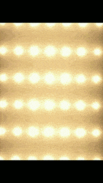 a row of lights are shining on a wall .