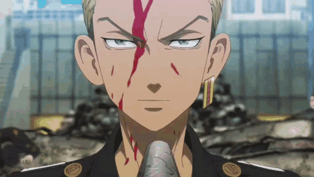 a close up of a man 's face with blood coming out of it .