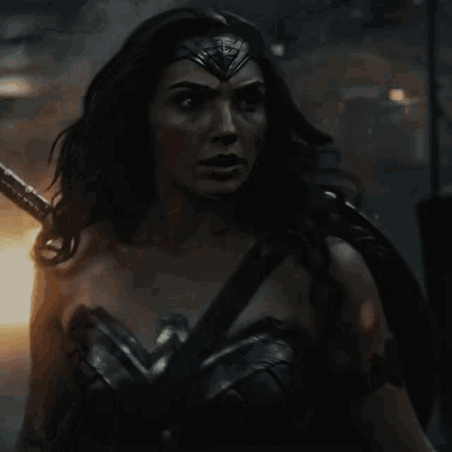 a woman in a wonder woman costume holds a sword