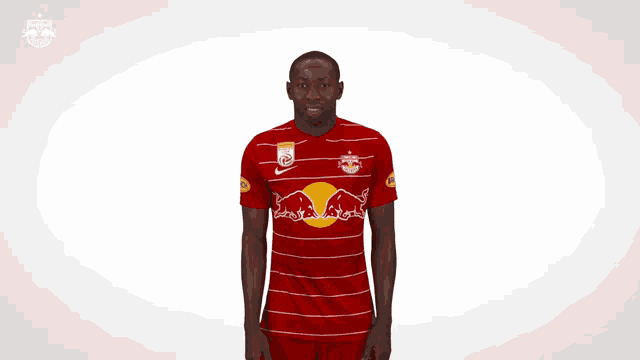 a man in a red and white striped shirt with a red bull on it