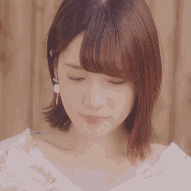 a close up of a woman 's face with a serious look on her face