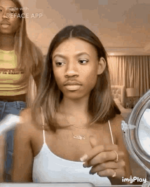 a woman is looking at herself in a mirror with the words made with reface app at the bottom