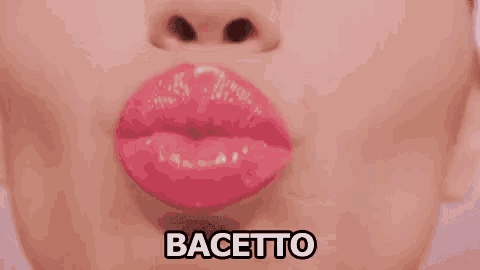 a close up of a woman 's face with a kiss on it and the word bacetti written below it