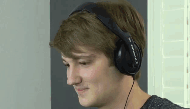 a young man wearing a pair of sennheiser headphones on his head