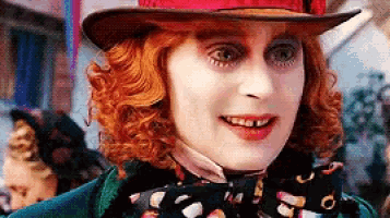 the mad hatter from alice in wonderland is wearing a red hat and a bow tie .