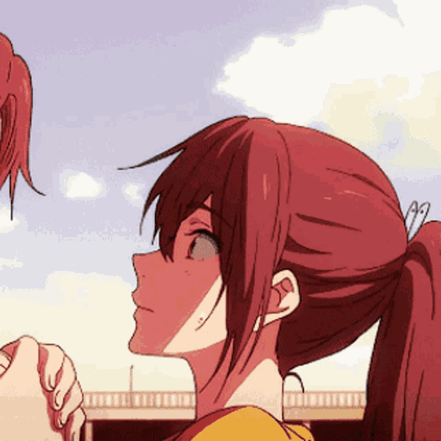 a girl with red hair and a ponytail looks up at something
