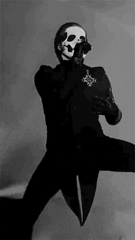 a black and white photo of a person in a skeleton costume holding a microphone .