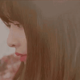 a close up of a woman 's face with long hair .