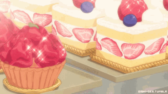 a bunch of cakes with strawberries and blueberries are on display