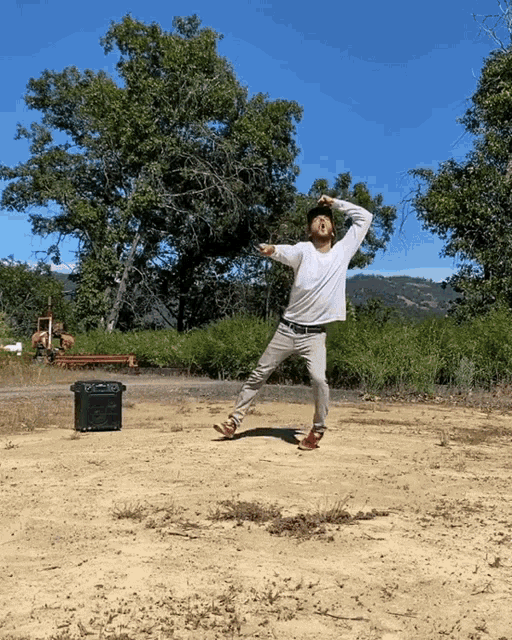 a man in a white shirt is throwing a frisbee