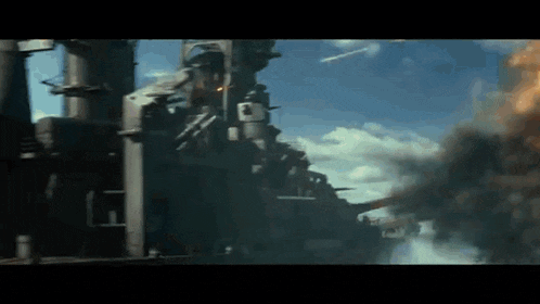 a large building is on fire with smoke coming out of it and a blue sky in the background