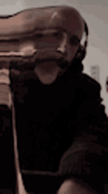 a person is smoking a hookah and there is a lot of smoke coming out of the pipe .
