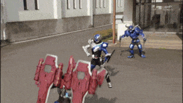 a man in a blue suit is fighting another man in a red suit