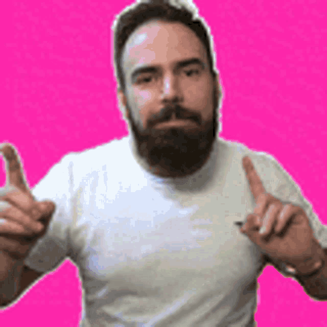 a man with a beard is wearing a white t-shirt and making a peace sign