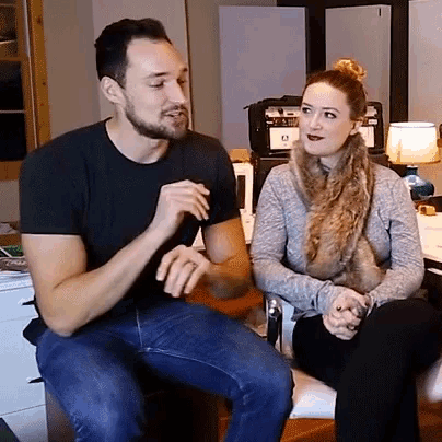a man and a woman are sitting next to each other and talking