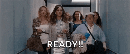 a group of women are walking down an elevator with the words `` ready ! ''