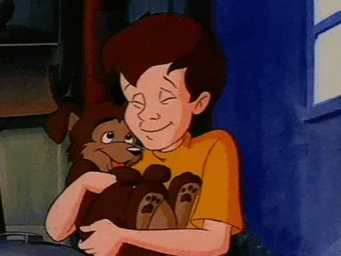 a cartoon boy is holding a stuffed animal in his arms and smiling .