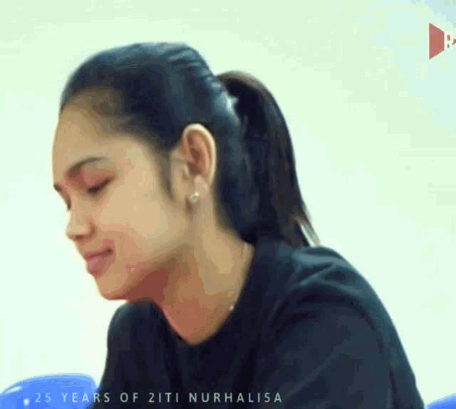 a woman with a ponytail and the words 25 years of 2iti nurhalisa on the bottom