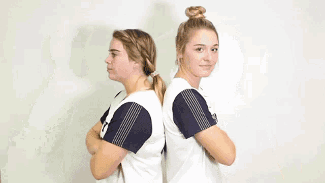 two women wearing navy jerseys number 41 and 2