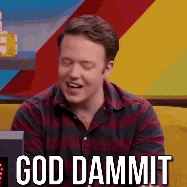 a man in a striped shirt is sitting in front of a sign that says " god dammit "