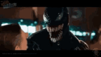 a close up of a person being attacked by a venom monster .