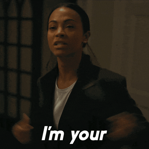 a woman in a white shirt and a black jacket says " i 'm your "