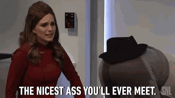 a woman in a red sweater is talking to a man in a black hat .