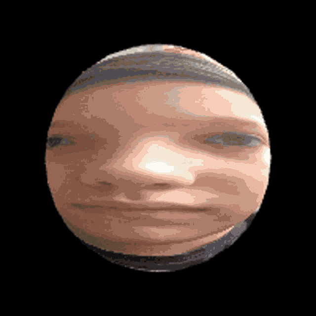 a close up of a person 's face in a circle with a black background