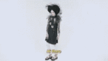a woman wearing a black hat and a black dress is standing in front of a white background .