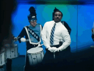 a man in a marching band uniform has the word lomax on his hat