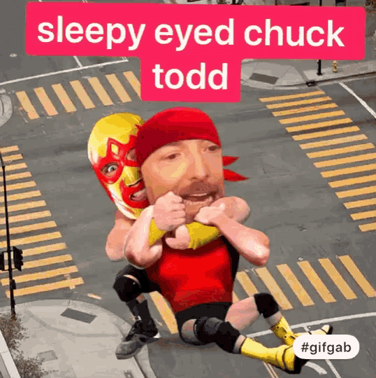 a man in a red shirt is wrestling another man in a yellow mask with the words sleepy eyed chuck todd above him