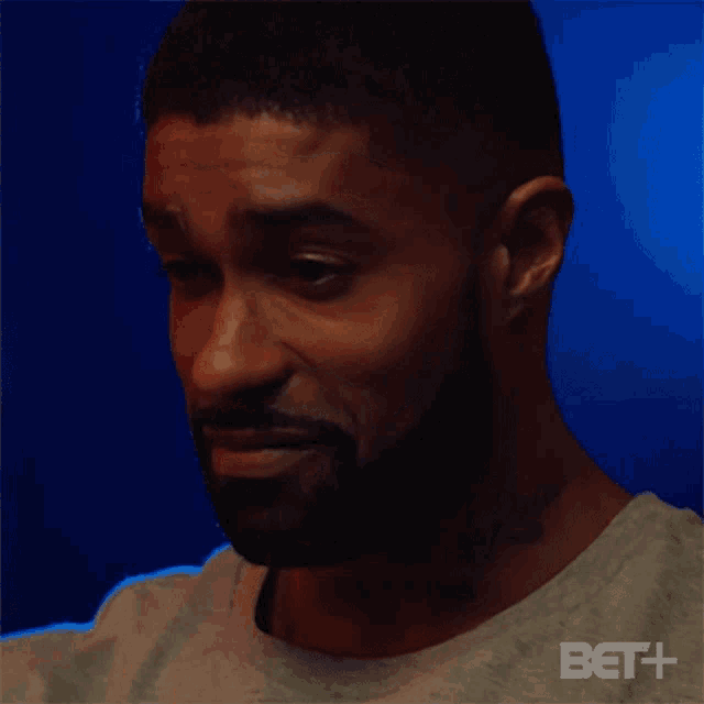 a man with a beard is making a face and saying aight