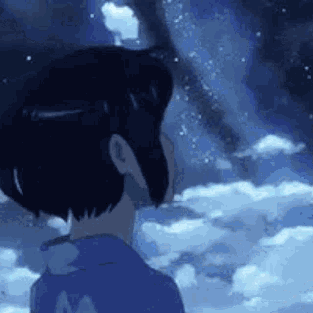 a person is standing in front of a cloudy sky .