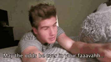 a man laying on a bed with the words may the odds be ever in your faavahhh written below him
