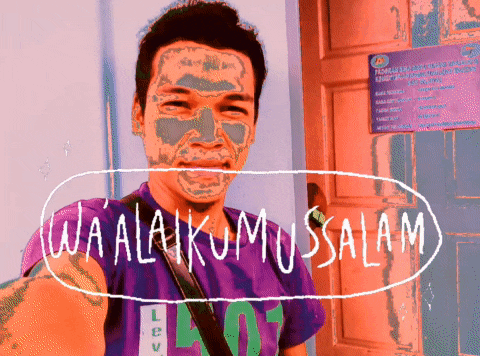 a man with a mask on his face is standing in front of a sign that says wa alaikumussalam