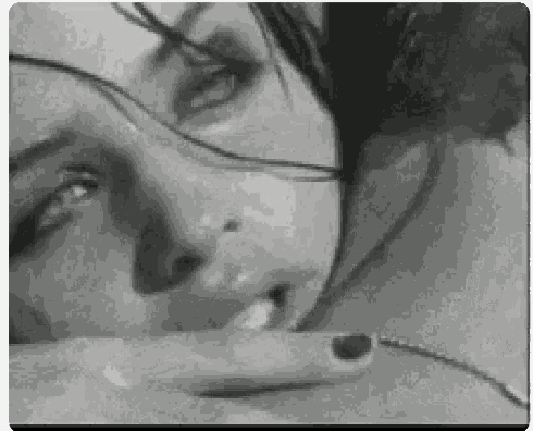 a black and white photo of a woman kissing another woman 's neck .