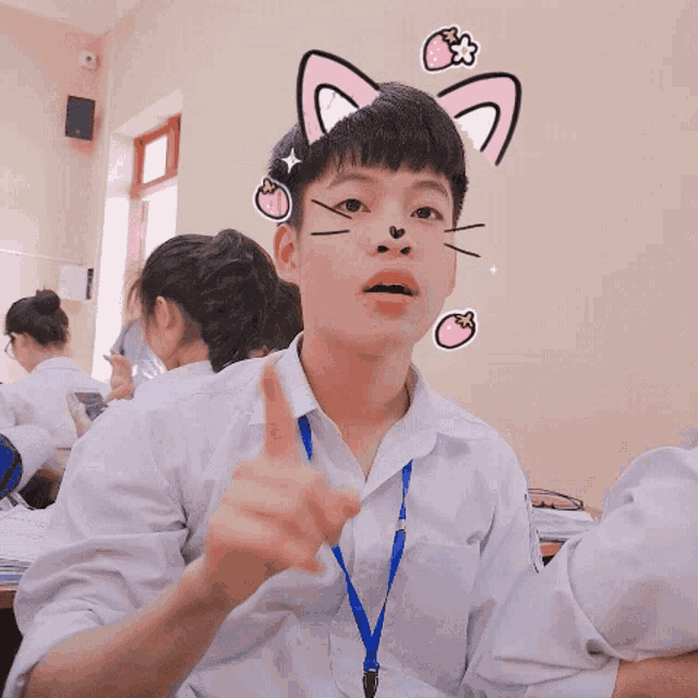 a boy in a white shirt with a blue lanyard around his neck has a cat face on his face