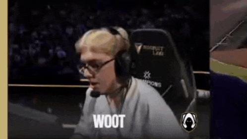 a man wearing headphones is sitting in a chair with the word woot on the screen .