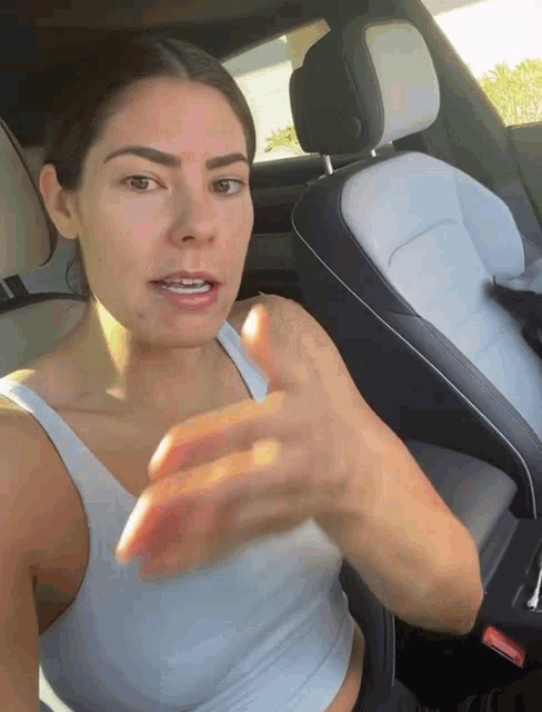 a woman is sitting in the back seat of a car